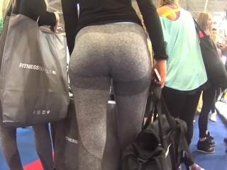 Two candid fit asses in grey yoga pants walking