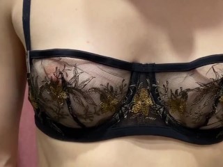Girl in fitting room is trying on bras